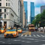 Yellow taxis and bustling traffic on a vibrant New York City street.